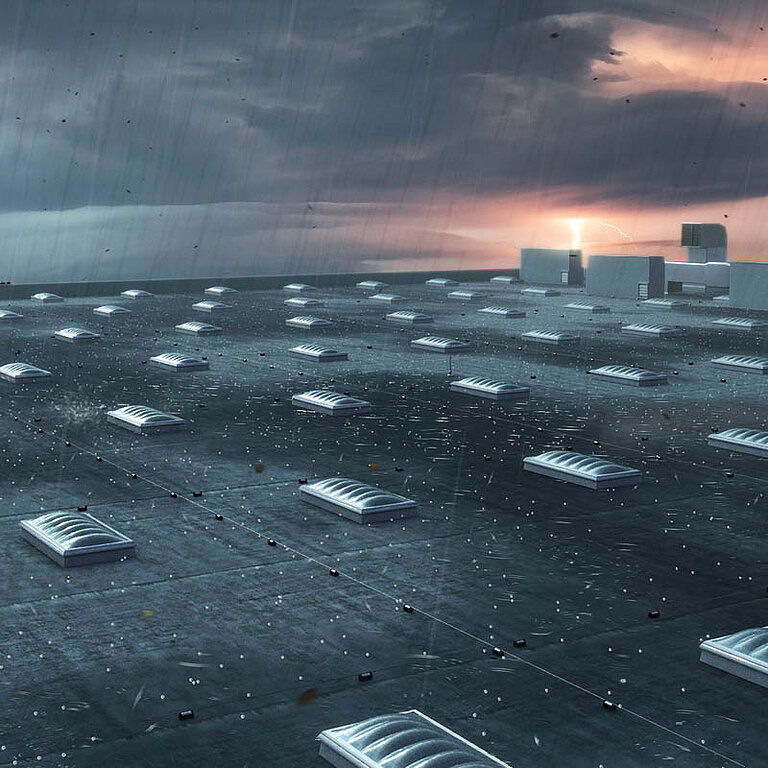 Viele LAMILUX Lichtkuppeln F100 W auf großflächigem Flachdach bei Dämmerung und Regen