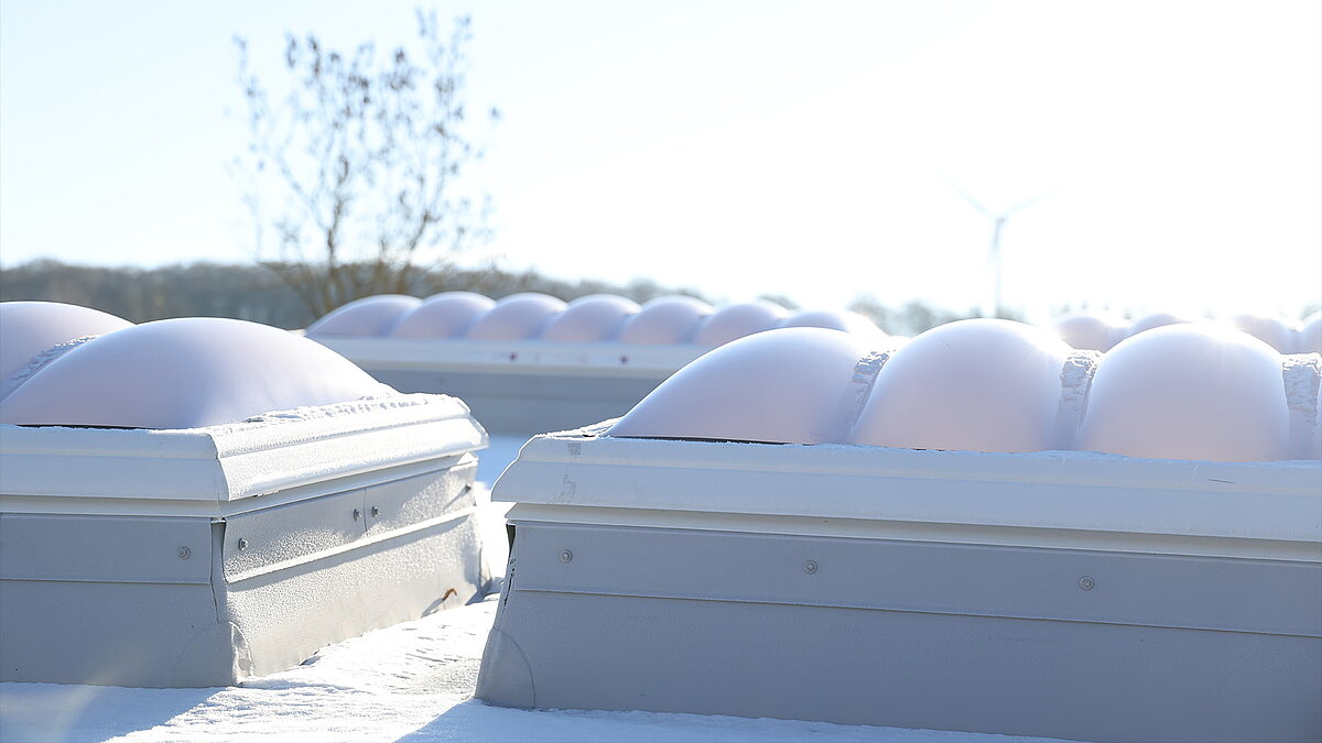 Mehrere F100W Lichtkuppeln, die vom Schnee bedeckt sind.