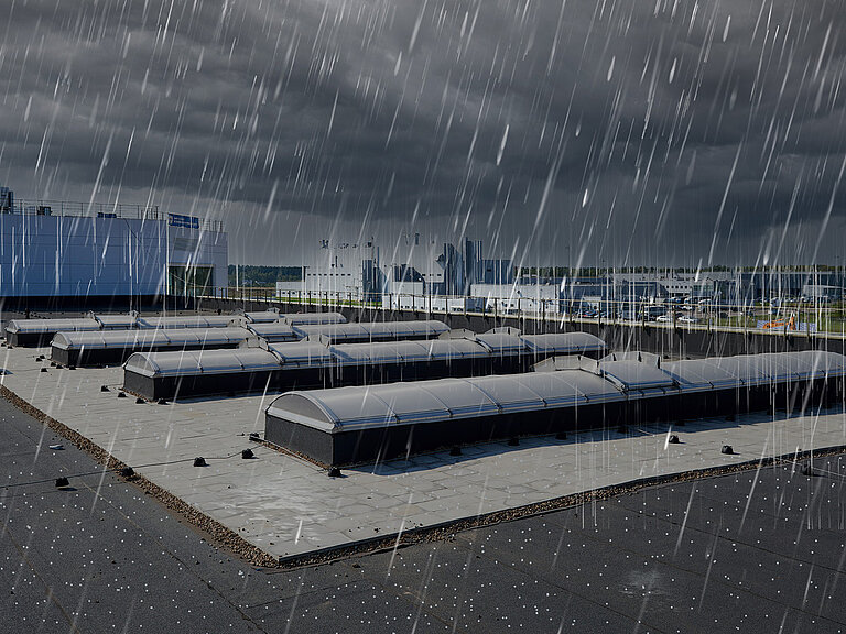 Flachdach mit mehreren Tageslichtelementen bei starkem Niederschlag