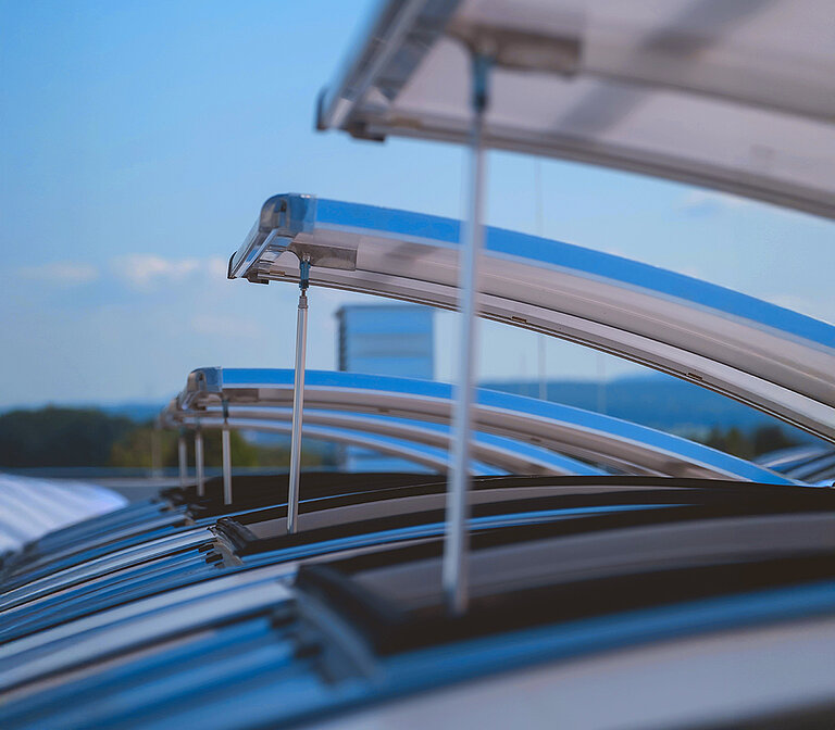Geöffnetes LAMILUX Lichtband B auf Industriedach unter blauem Himmel